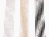 close-up photo of three strips of silicone horsehair elastic. Horsehair elastic with zig zag silicone lines, Gripper elastic. Wig band