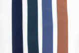 4 colors of elastic suspenders laid out next to each other; Black, Forest Green, Slate Blue and Camel