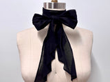 Black cotton lawn cravat tied in a bow on a mannequin