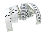 Curled white measuring tape showing braille on one side and printed numbers on the other.