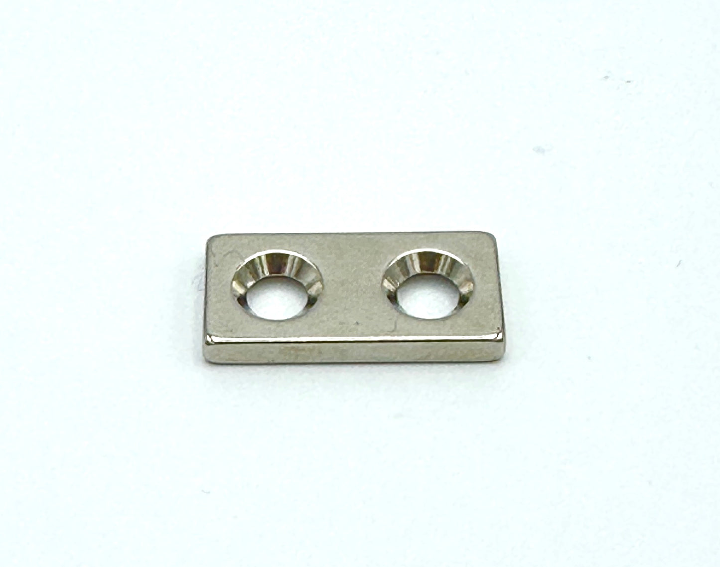 eighth inch thick magnetic bar with 2 countersunk holes for easy sewing