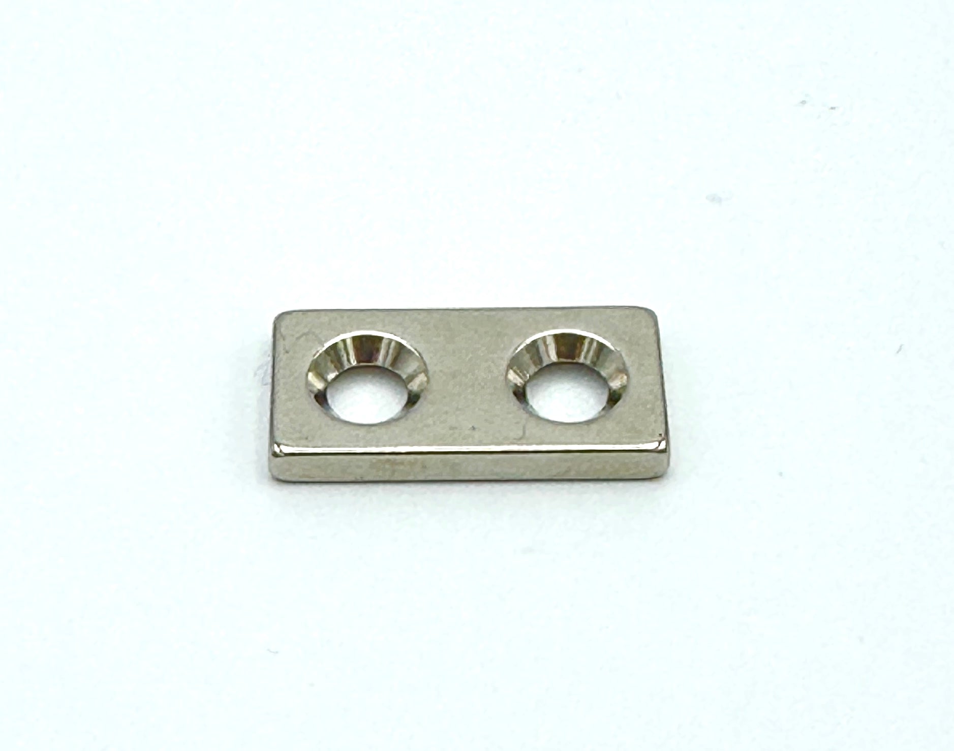 eighth inch thick magnetic bar with 2 countersunk holes for easy sewing
