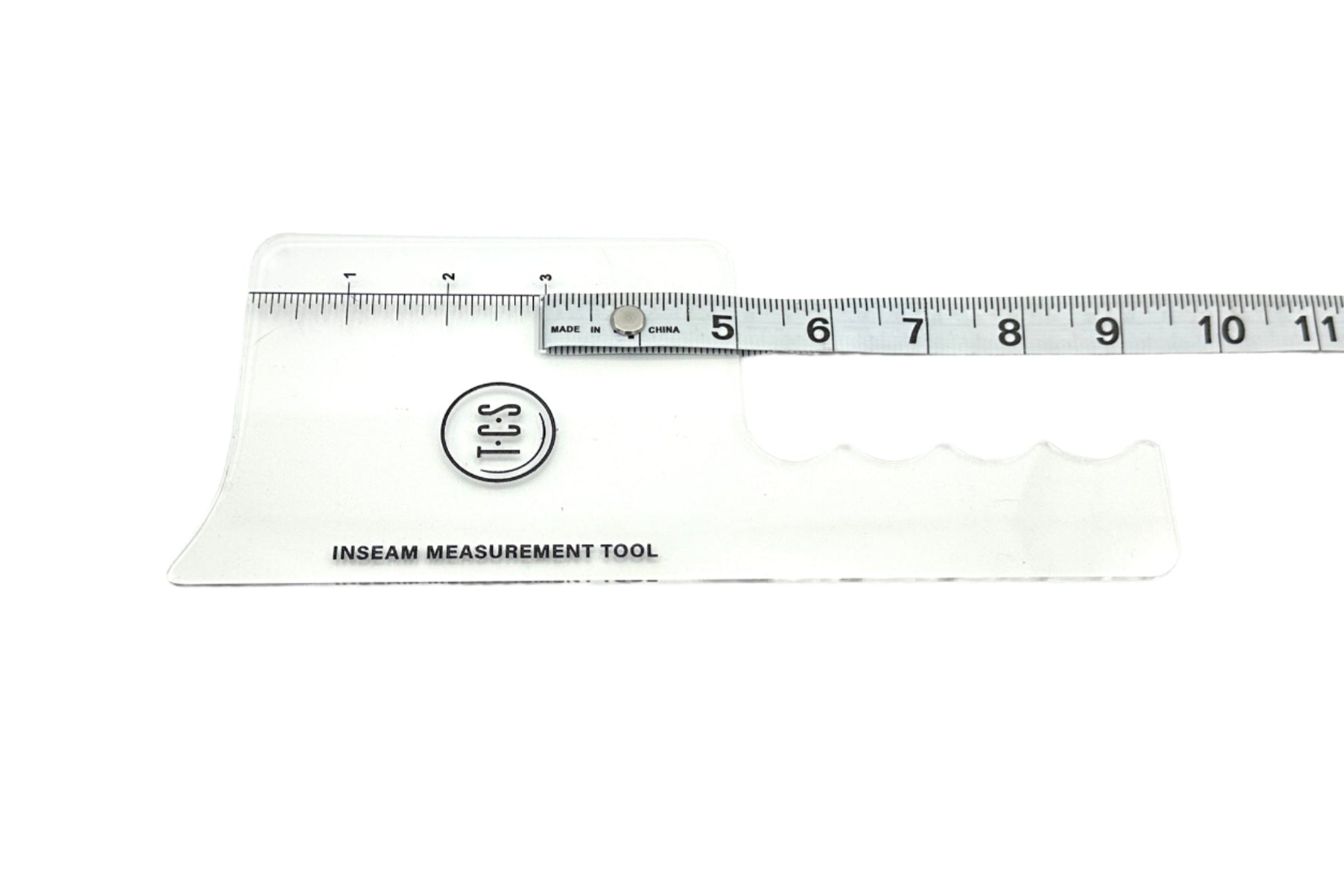 A clear plastic inseam measurement tool with attached measuring tape