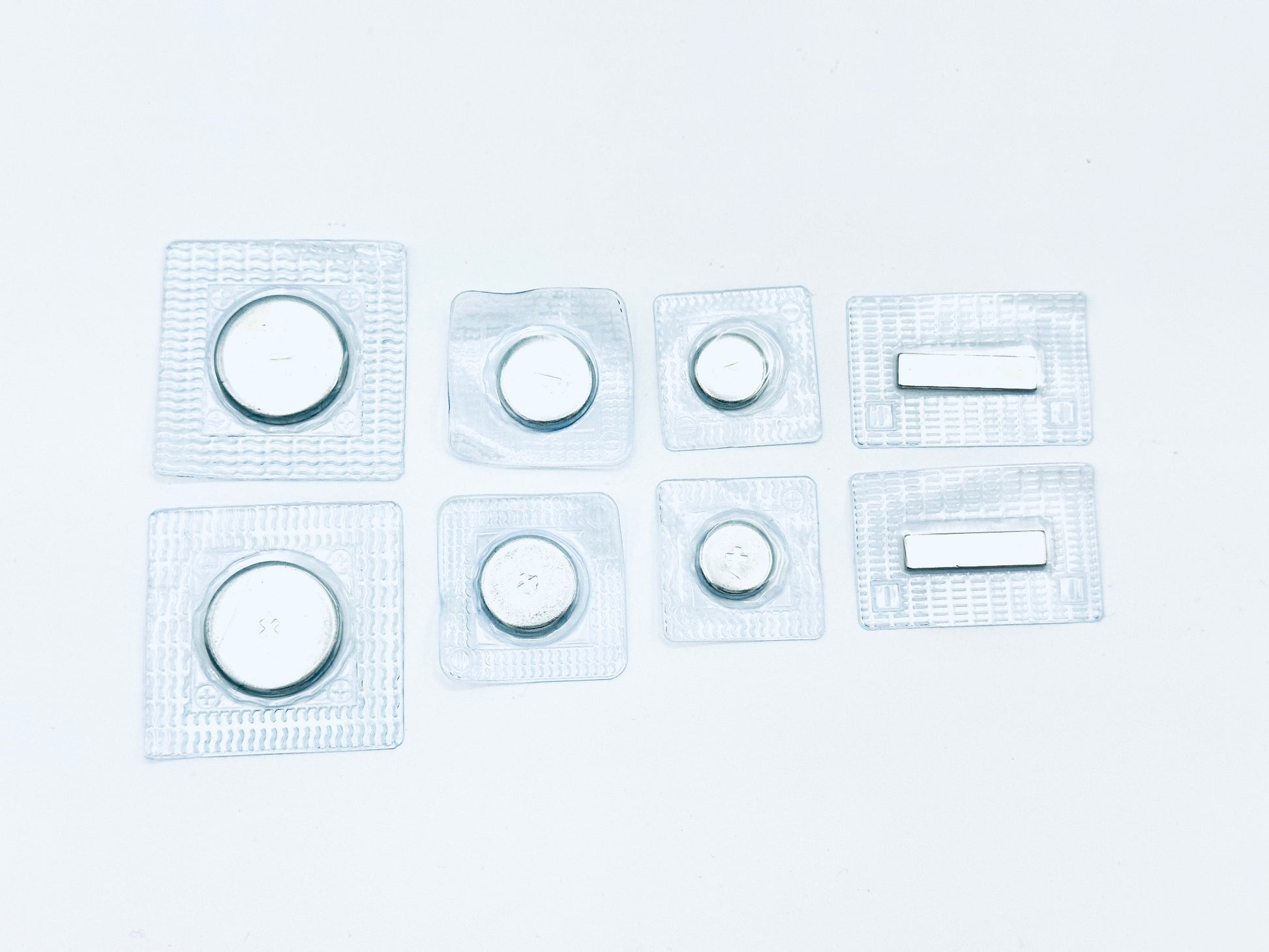 4 pairs of sew in magnets in plastic; 1 pair 1" large disk, 1 pair 3/4" disk, 1 pair 1/2" disk, 1 pair thin bar