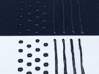 Black and White fabric with dots and stripes of black sock stop painted on them