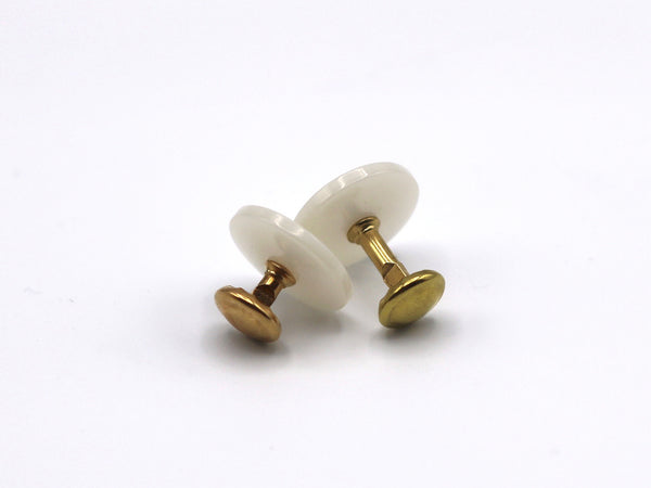 A pair of goldtone collar studs