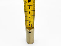 Weighted metal end of tape measure with centimeter side showing