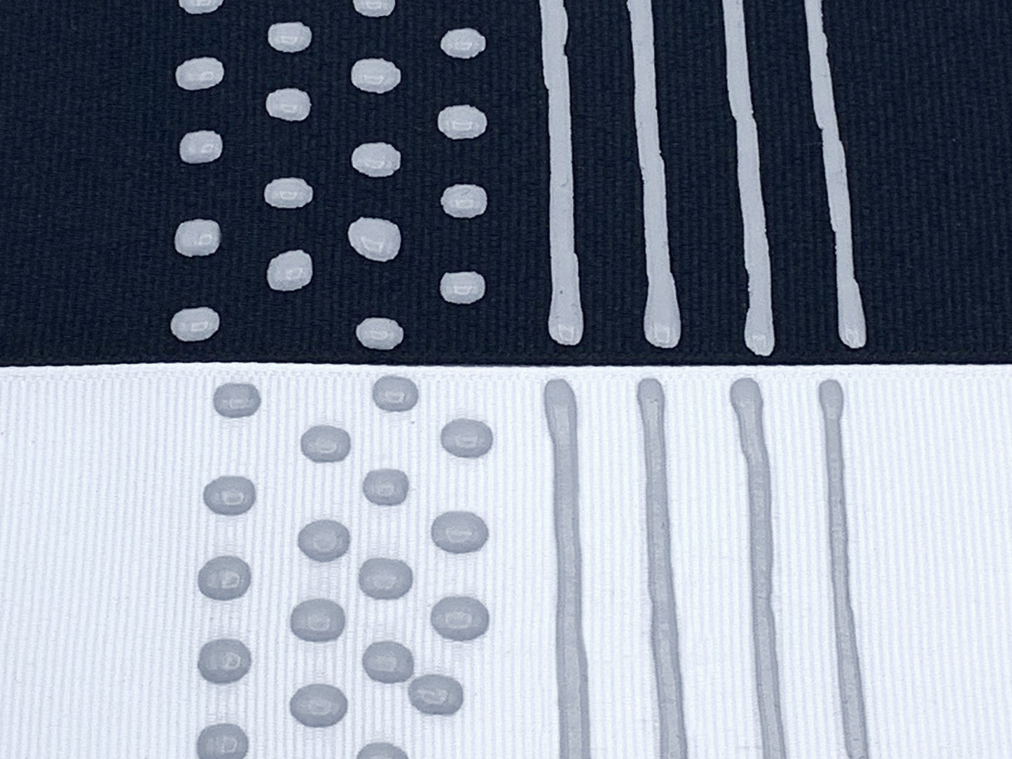 Black and white fabric with grey sock stop painted on in dots and stripes