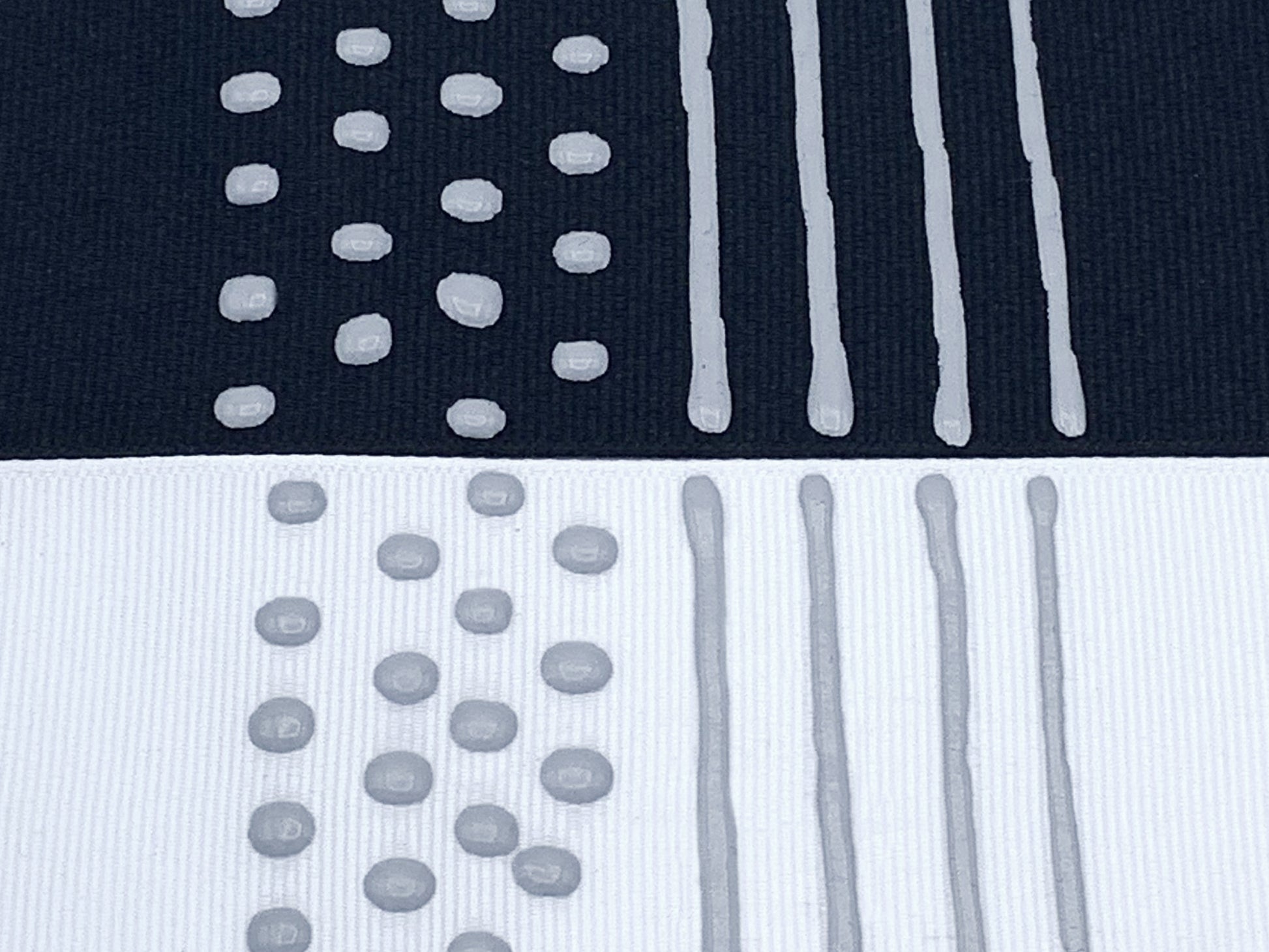 Black and white fabric with grey sock stop painted on in dots and stripes