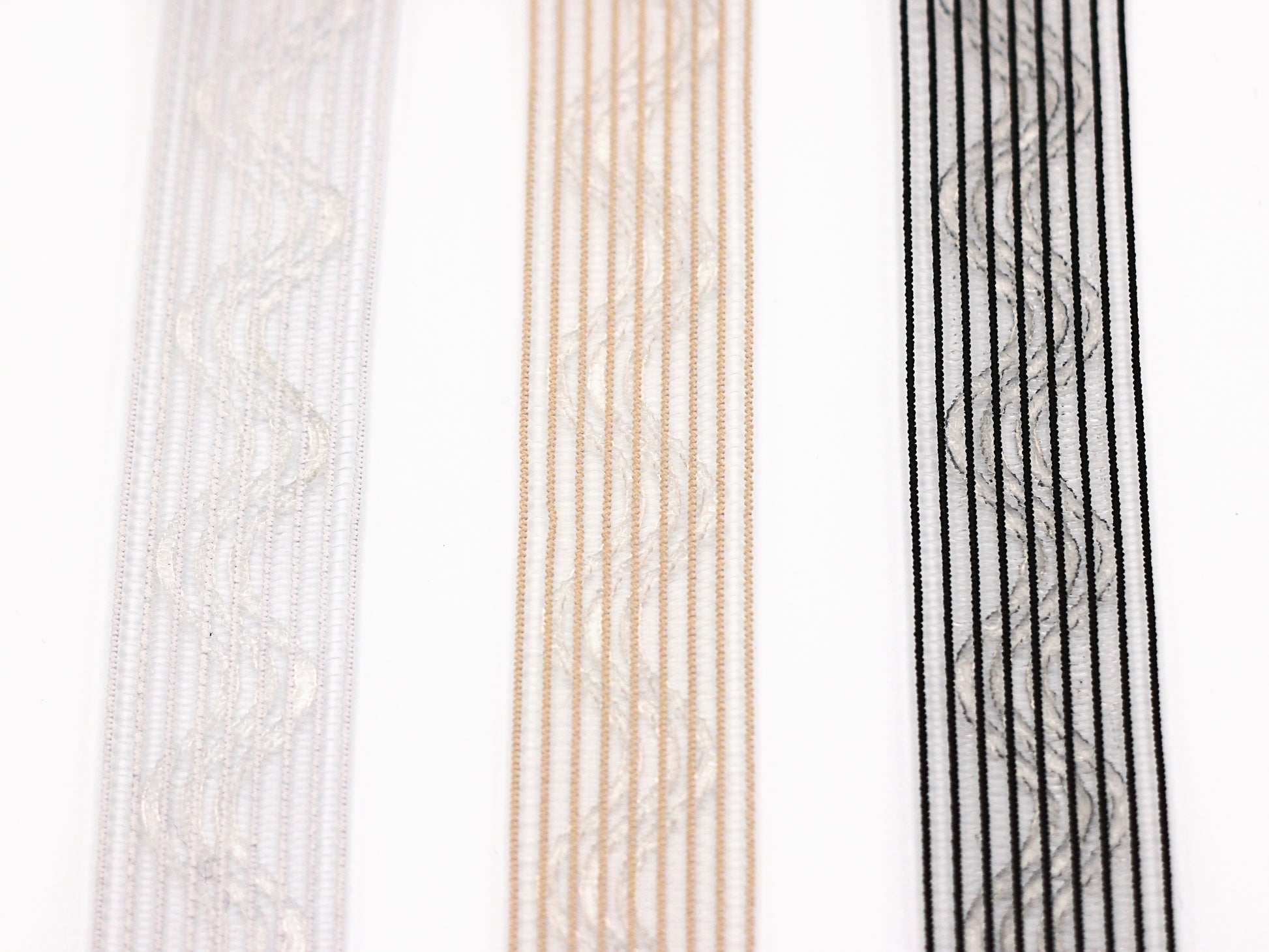 close-up photo of three strips of silicone horsehair elastic. Horsehair elastic with zig zag silicone lines, Gripper elastic. Wig band