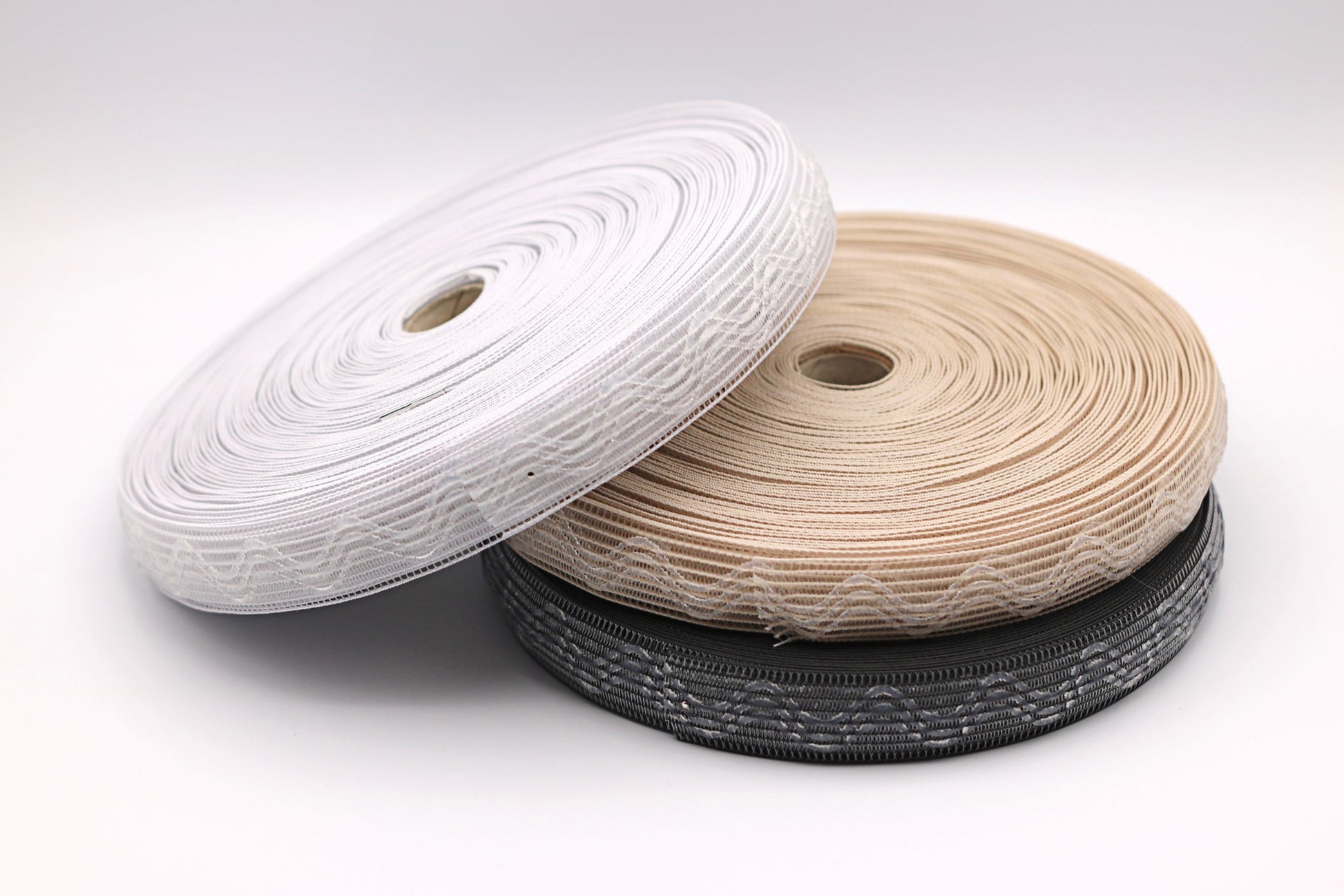 Silicone horsehair elastic. Gripper Elastic. Wig band. Three spools, one of white, beige and black