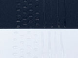 Black and white fabric with transparent sock stop drawn on in dots and stripes
