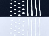 Black and White fabric with White sock stop drawn on in dots and stripes